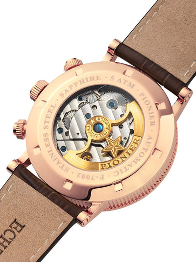 Rose gold Pionier watch with a visible mechanical movement on a dark brown strap.