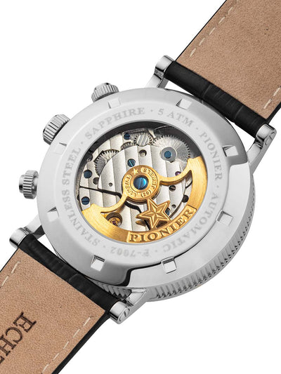 Close-up of a watch with visible mechanical components and 'Pionier' branding.
