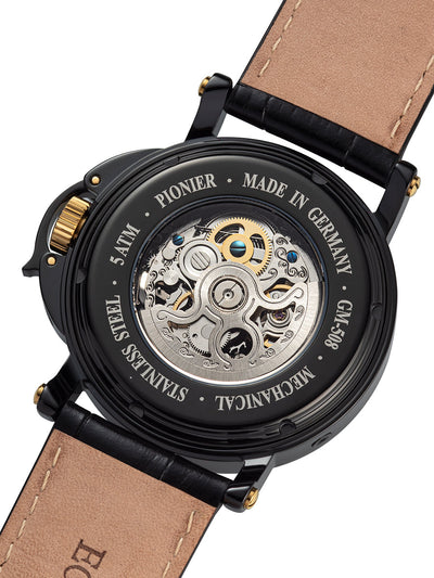 Open back case with silver color movement with deployment buckle and leather band.